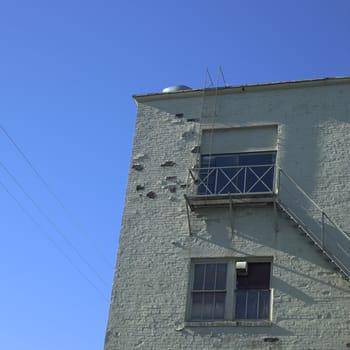 Rundown brick building and blue sky