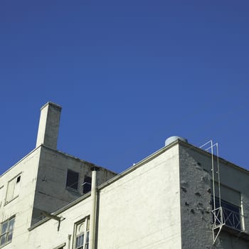 Rundown brick building and blue sky