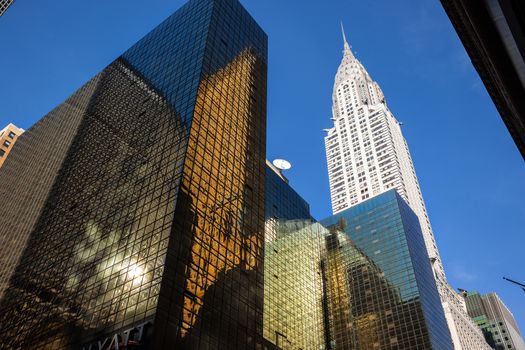 NEW YORK, USA - Jun 01, 2014: Chrysler building and manhattan modern architecture. Manhattan is the most densely populated of the five boroughs of New York City