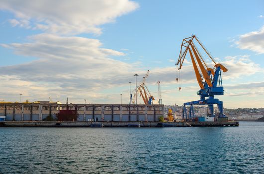 Crane working with container cargo in Trieste shipyard