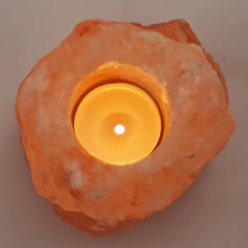 Candle in pink salt stone, square image