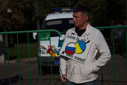 Moscow, Russia - September 21, 2014. Unknown opposition with the poster peace March Peace March in Moscow against war with Ukraine