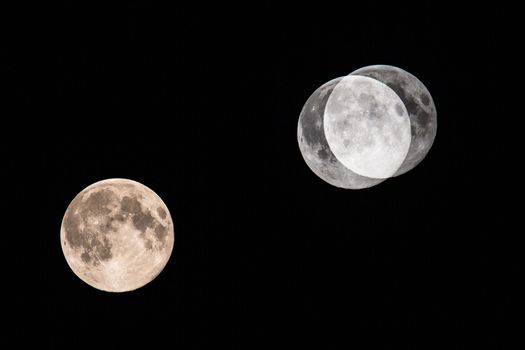 Big moon on dark night sky (multiple exposure showing the progression of the moon through the sky)