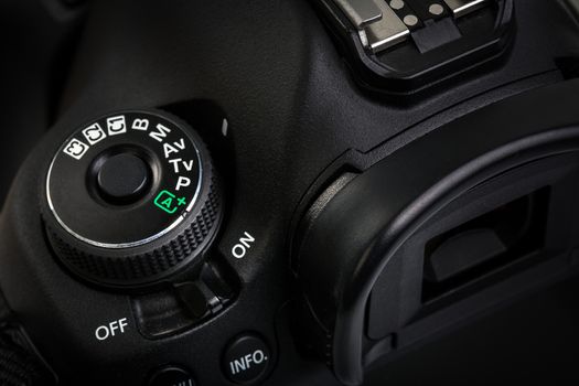 Professional modern DSLR camera - detail of the top LCD with settings - shutter speer, aperture, ISO, AF mode, battery info, RAW format indication,...