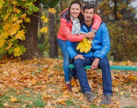 Couple on a bench in the autumn park