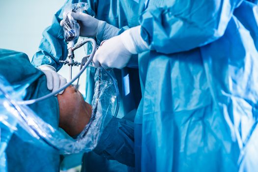 Knee surgery, Orthopedic Operation  - two surgeons performing a knee surgery on a patient (shallow DOF; color toned image)