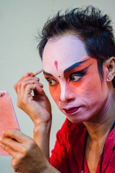 BANGKOK - OCTOBER 22: Unidentified Chinese opera actress applies makeup backstage at Theaters of Thailand's ethnic Chinese in Chinatown on October 27, 2014 in Bangkok, Thailand.