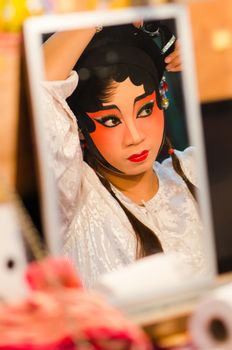 BANGKOK - OCTOBER 22: Unidentified Chinese opera actress applies makeup backstage at Theaters of Thailand's ethnic Chinese in Chinatown on October 27, 2014 in Bangkok, Thailand.