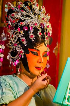 BANGKOK - OCTOBER 22: Unidentified Chinese opera actress applies makeup backstage at Theaters of Thailand's ethnic Chinese in Chinatown on October 27, 2014 in Bangkok, Thailand.