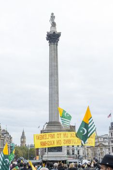 LONDON, UK - OCTOBER 26: Protesters wave Kashmiri flags in Trafalgar Square. The protest, named the Million March, denounced the human rights violation by India in Kashmir. October 26, 2014 in London.