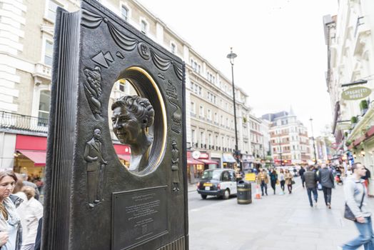 LONDON, UK - OCTOBER 26: Agatha Christie book shaped memorial with busy street in the background. The bronze memorial was unveiled on the 18 November 2012. October 26, 2014 in London.