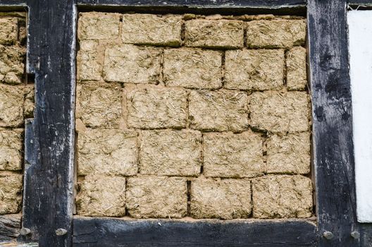 Medieval house wall plastered with clay, in the bar