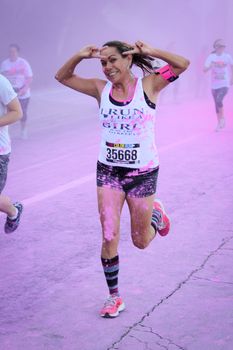 Ventura, CA - OCTOBER 18 : Participants coming through the pink color station at The Color Run 2014 in Ventura. OCTOBER 18, 2014 in Ventura, CA.