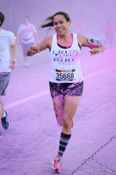 Ventura, CA - OCTOBER 18 : Participants coming through the pink color station at The Color Run 2014 in Ventura. OCTOBER 18, 2014 in Ventura, CA.