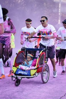 Ventura, CA - OCTOBER 18 : Participants coming through the pink color station at The Color Run 2014 in Ventura. OCTOBER 18, 2014 in Ventura, CA.