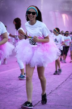 Ventura, CA - OCTOBER 18 : Participants coming through the pink color station at The Color Run 2014 in Ventura. OCTOBER 18, 2014 in Ventura, CA.