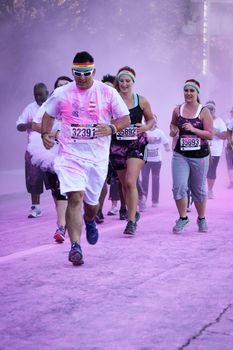 Ventura, CA - OCTOBER 18 : Participants coming through the pink color station at The Color Run 2014 in Ventura. OCTOBER 18, 2014 in Ventura, CA.