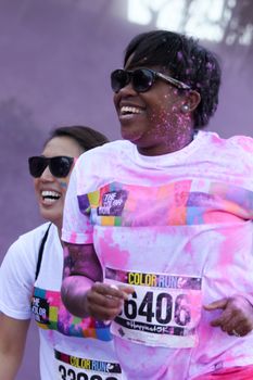 Ventura, CA - OCTOBER 18 : Participants coming through the pink color station at The Color Run 2014 in Ventura. OCTOBER 18, 2014 in Ventura, CA.