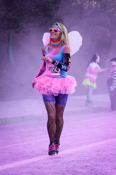 Ventura, CA - OCTOBER 18 : Participants coming through the pink color station at The Color Run 2014 in Ventura. OCTOBER 18, 2014 in Ventura, CA.