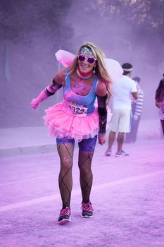 Ventura, CA - OCTOBER 18 : Participants coming through the pink color station at The Color Run 2014 in Ventura. OCTOBER 18, 2014 in Ventura, CA.