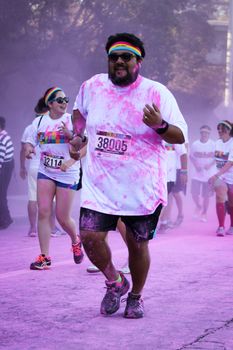 Ventura, CA - OCTOBER 18 : Participants coming through the pink color station at The Color Run 2014 in Ventura. OCTOBER 18, 2014 in Ventura, CA.