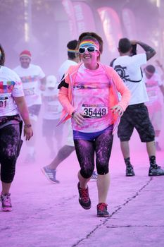 Ventura, CA - OCTOBER 18 : Participants coming through the pink color station at The Color Run 2014 in Ventura. OCTOBER 18, 2014 in Ventura, CA.