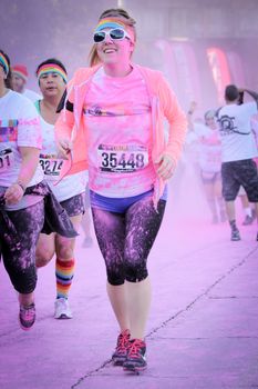 Ventura, CA - OCTOBER 18 : Participants coming through the pink color station at The Color Run 2014 in Ventura. OCTOBER 18, 2014 in Ventura, CA.