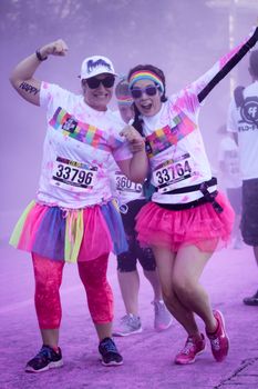 Ventura, CA - OCTOBER 18 : Participants coming through the pink color station at The Color Run 2014 in Ventura. OCTOBER 18, 2014 in Ventura, CA.