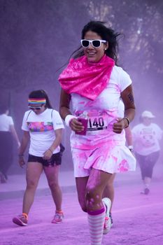 Ventura, CA - OCTOBER 18 : Participants coming through the pink color station at The Color Run 2014 in Ventura. OCTOBER 18, 2014 in Ventura, CA.