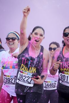 Ventura, CA - OCTOBER 18 : Participants coming through the pink color station at The Color Run 2014 in Ventura. OCTOBER 18, 2014 in Ventura, CA.