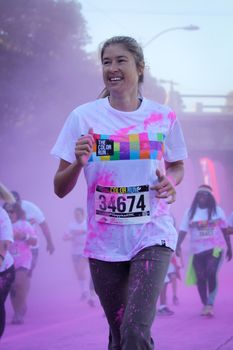 Ventura, CA - OCTOBER 18 : Participants coming through the pink color station at The Color Run 2014 in Ventura. OCTOBER 18, 2014 in Ventura, CA.