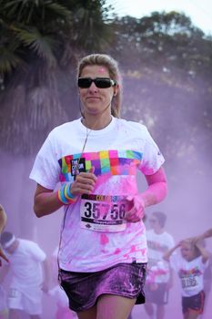 Ventura, CA - OCTOBER 18 : Participants coming through the pink color station at The Color Run 2014 in Ventura. OCTOBER 18, 2014 in Ventura, CA.