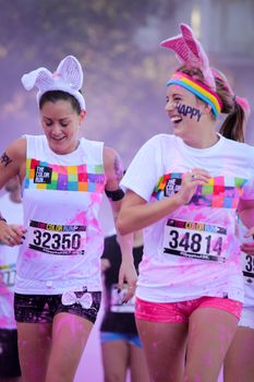 Ventura, CA - OCTOBER 18 : Participants coming through the pink color station at The Color Run 2014 in Ventura. OCTOBER 18, 2014 in Ventura, CA.