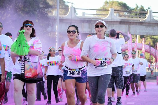 Ventura, CA - OCTOBER 18 : Participants coming through the pink color station at The Color Run 2014 in Ventura. OCTOBER 18, 2014 in Ventura, CA.