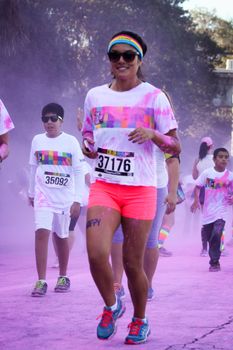 Ventura, CA - OCTOBER 18 : Participants coming through the pink color station at The Color Run 2014 in Ventura. OCTOBER 18, 2014 in Ventura, CA.