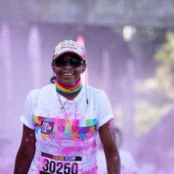 Ventura, CA - OCTOBER 18 : Participants coming through the pink color station at The Color Run 2014 in Ventura. OCTOBER 18, 2014 in Ventura, CA.