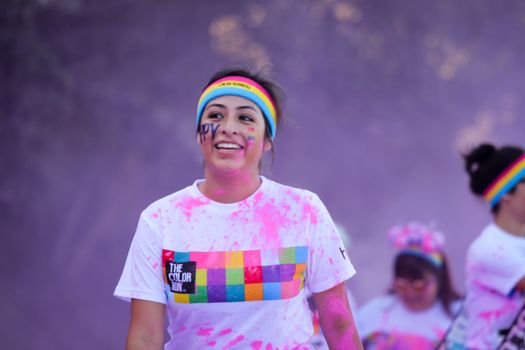 Ventura, CA - OCTOBER 18 : Participants coming through the pink color station at The Color Run 2014 in Ventura. OCTOBER 18, 2014 in Ventura, CA.