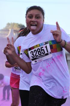 Ventura, CA - OCTOBER 18 : Participants coming through the pink color station at The Color Run 2014 in Ventura. OCTOBER 18, 2014 in Ventura, CA.