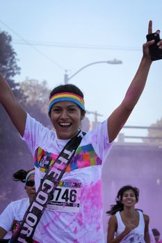 Ventura, CA - OCTOBER 18 : Participants coming through the pink color station at The Color Run 2014 in Ventura. OCTOBER 18, 2014 in Ventura, CA.