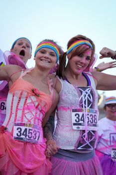 Ventura, CA - OCTOBER 18 : Participants coming through the pink color station at The Color Run 2014 in Ventura. OCTOBER 18, 2014 in Ventura, CA.