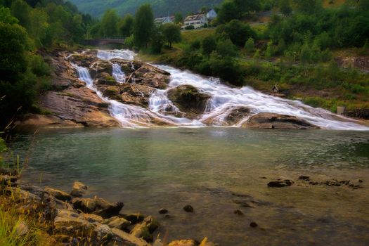 Green fjord and waterfall in Geiranger, Norway