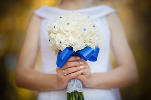 Wedding bouquet in hands of the bride