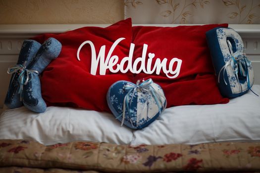 word white wedding on the beautiful red pillow