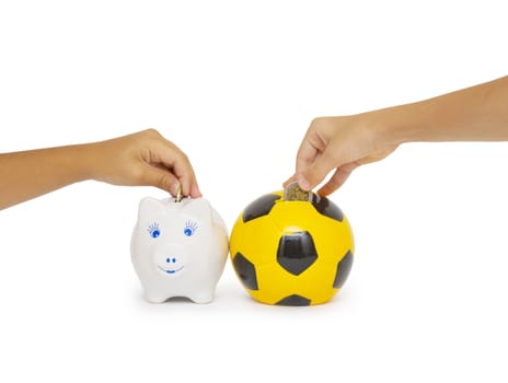 Closeup of woman's hand inserting coin in moneybox