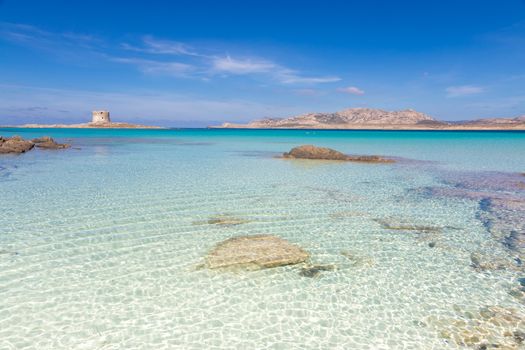 Stone tower on a beautiful turquoise blue mediterranean Pelosa beach near Stintino,Sardinia, Italy.