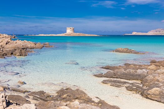 Stone tower on a beautiful turquoise blue mediterranean Pelosa beach near Stintino,Sardinia, Italy.