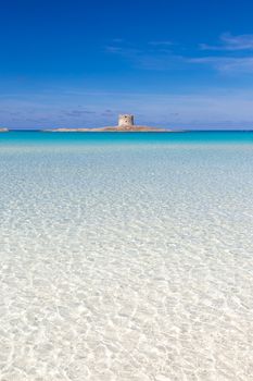 Stone tower on a beautiful turquoise blue mediterranean Pelosa beach near Stintino,Sardinia, Italy.