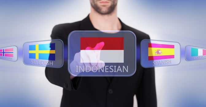 Hand pushing on a touch screen interface, choosing language or country, Indonesia
