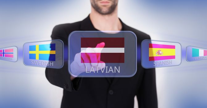 Hand pushing on a touch screen interface, choosing language or country, Latvia