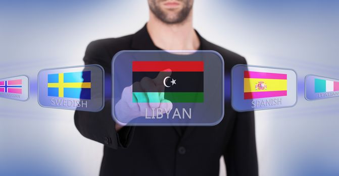 Hand pushing on a touch screen interface, choosing language or country, Libya